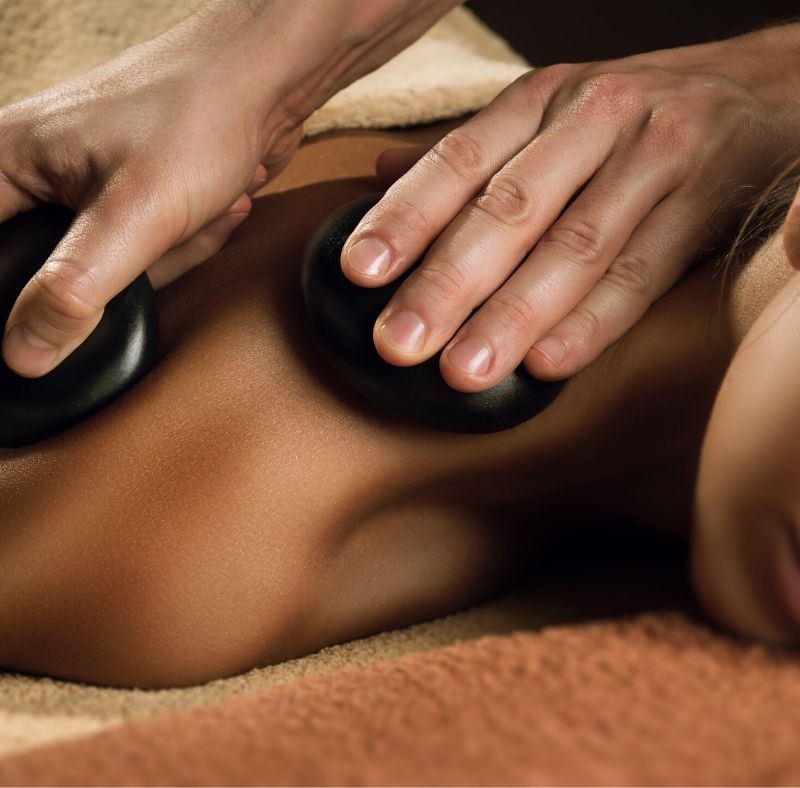 hot stone woman massage using stones